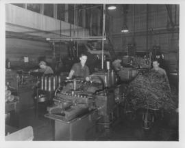 Workmen grinding shell cases and working with machines at Dominion Bridge Company