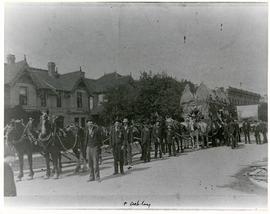 Horses and men leading novelty carriage