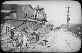 View of mucking hoist hauling excavated material to dump wagon on Pacific Avenue, looking east to...