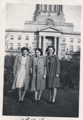 Three students from Normal School standing in front of Legislative Building
