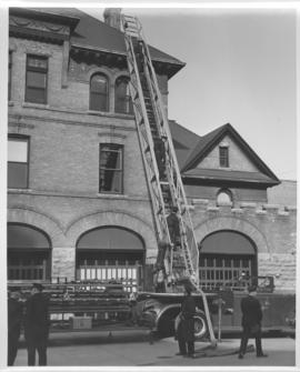 Winnipeg Fire Department aerial ladder truck in front of fire station