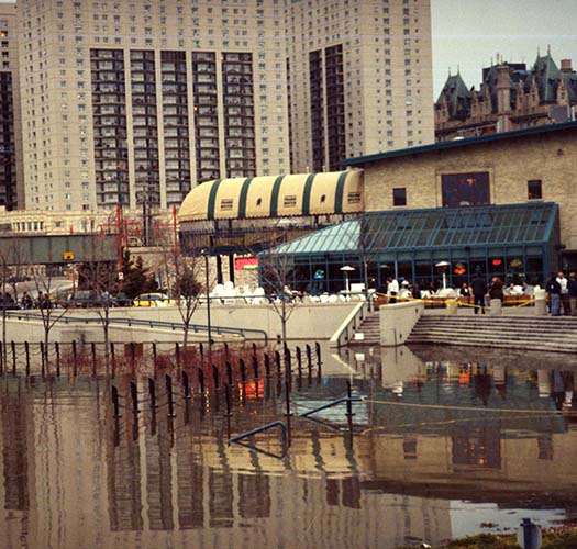 High waters at the Forks during the 1997 flood. Winnipeg Flood Record and Archives Committee collection (COW016379 File 22 Item 8).