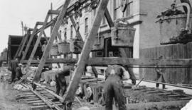 View of men mucking trench for 48-inch diameter Branch 1 aqueduct at Sta. 169+00 on Pacific Avenue