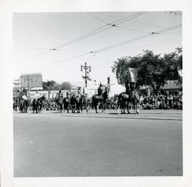 Winnipeg's 75th Anniversary parade - marchers on horseback carrying sign