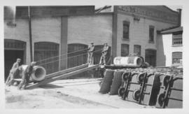 Men loading concrete forms onto truck