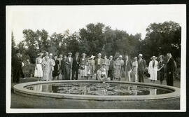 A group standing around the lily pond in Assiniboine Park